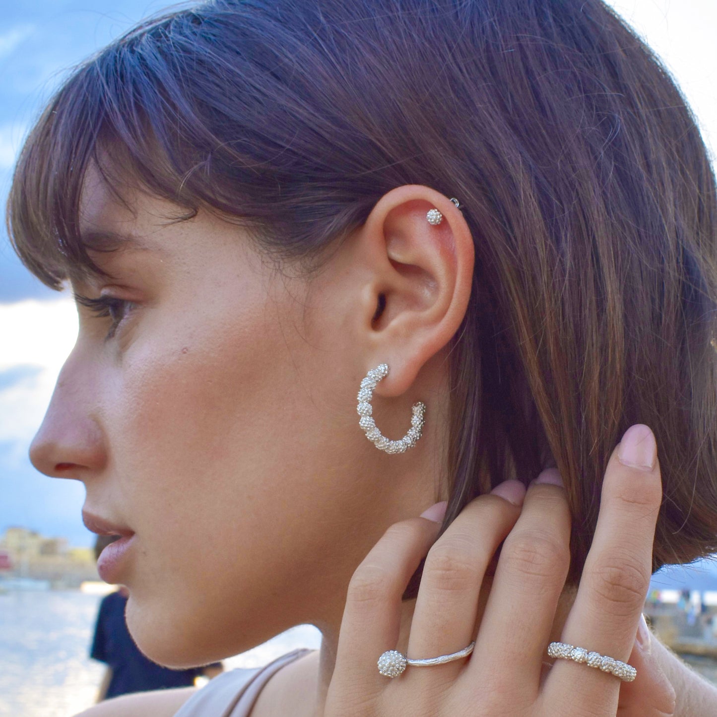 Exquisite hoop earrings crafted from high-quality sterling silver, each embellished with real acacia flowers meticulously preserved to capture the delicate beauty of their intricate blooms. These nature-inspired earrings offer a unique blend of craftsmanship and the timeless allure of natural acacia blossoms.