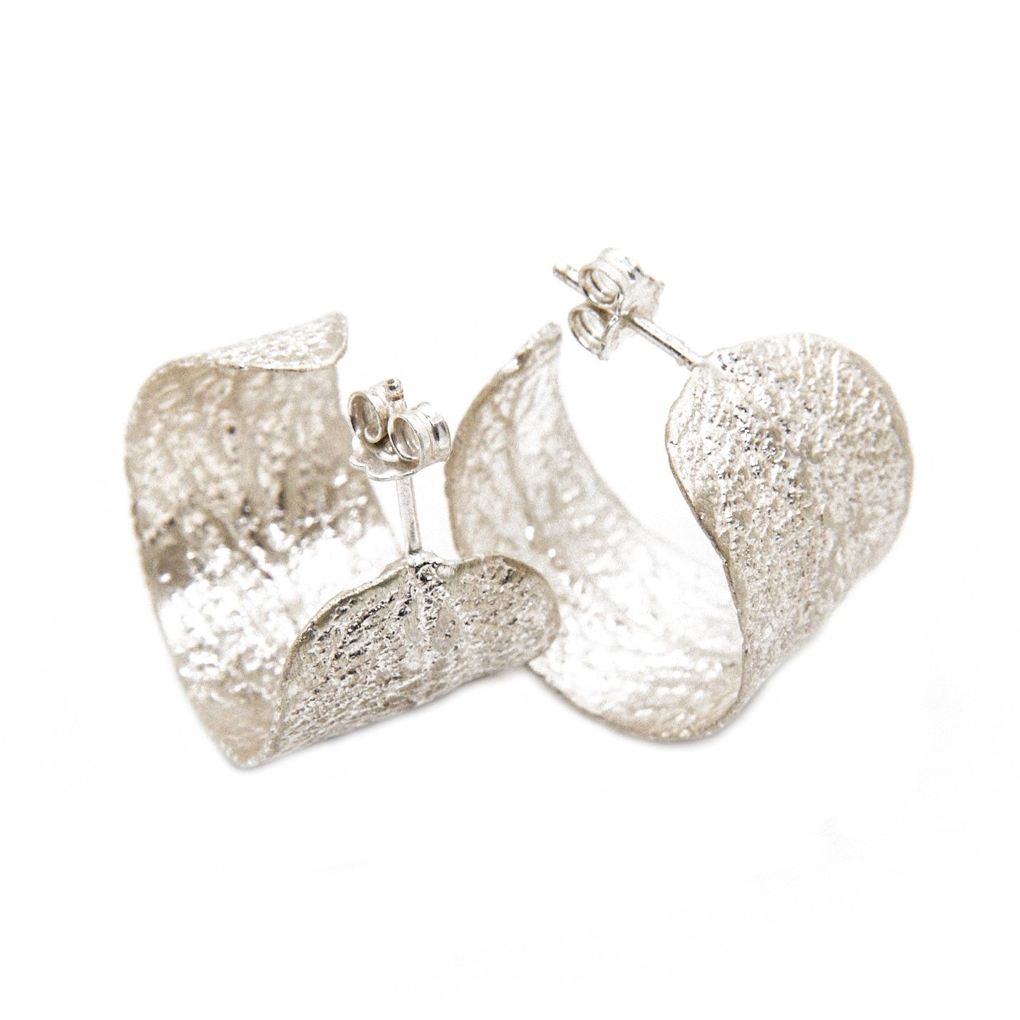 Sterling silver hoop earrings featuring real sage leaves, meticulously handcrafted in Greece, a fusion of nature's beauty and artisanal excellence.